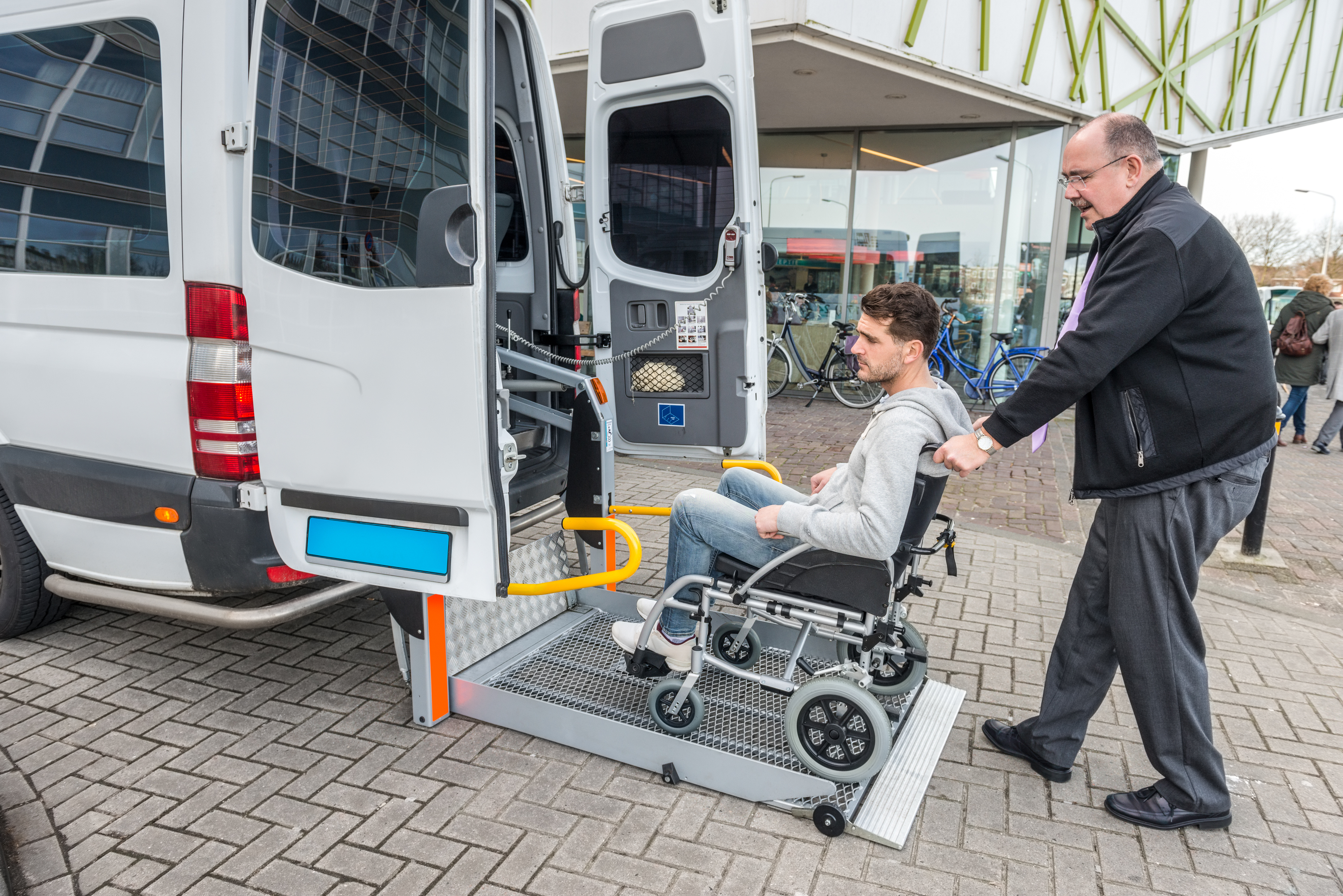 man in wheelchair loading into paratransit